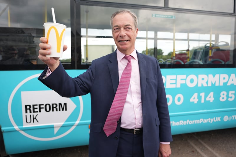 Reform UK leader Nigel Farage holding a McDonald’s banana milkshake after one was thrown at him in Essex
