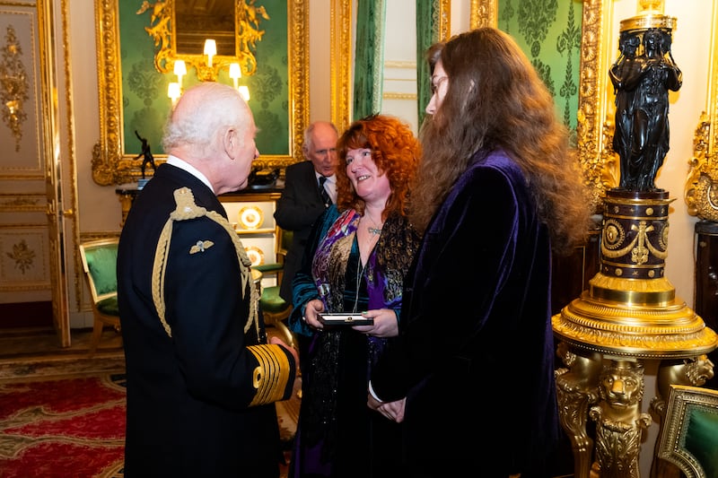 Charles presents an Elizabeth Emblem to Rebecca Lombard-Earl, for firefighter Fleur Lombard of Avon Fire and Rescue during the inaugural presentation ceremony at Windsor Castle