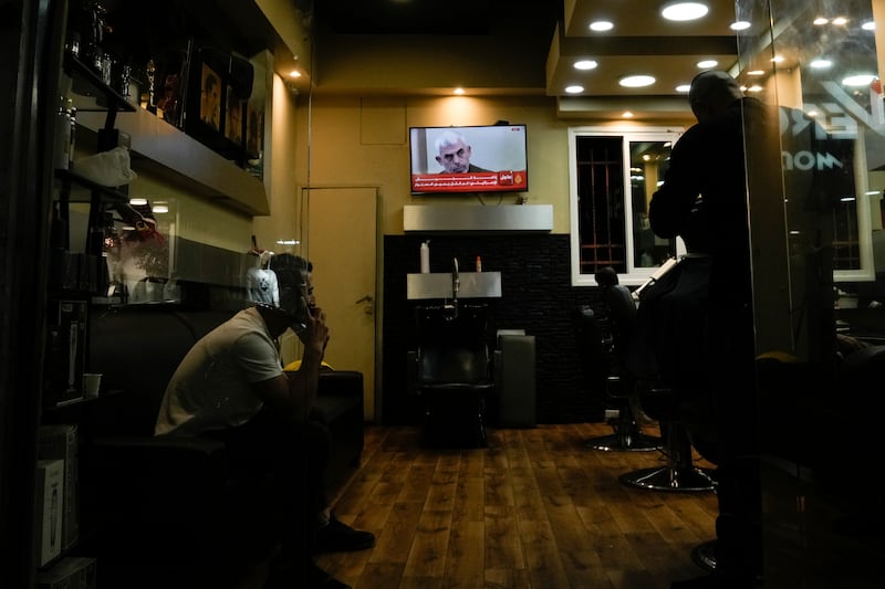 A photo of Hamas leader Yahya Sinwar is displayed on a TV screen at a barbershop in the West Bank city of Bethlehem (Mahmoud Illean/AP)