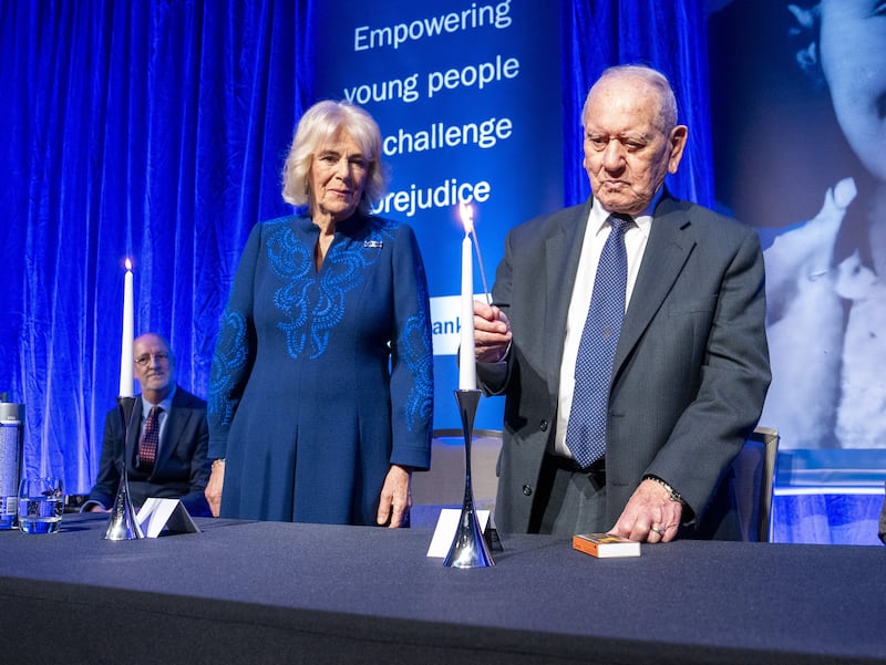 Queen Camilla watches Holocaust survivor Arem Hersch light a candle