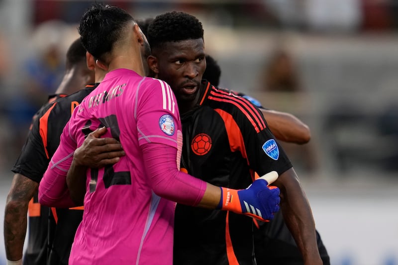 Colombia’s Jefferson Lerma, right, embraces goalkeeper Camilo Vargas after Colombia tied with Brazil (Godofredo A Vasquez/AP)
