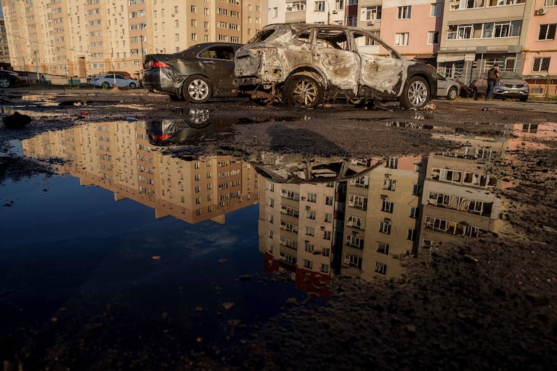 Destroyed cars are reflected in a pool of water after a Russian air strike on a residential neighbourhood in Sumy, Ukraine (Evgeniy Maloletka/AP)