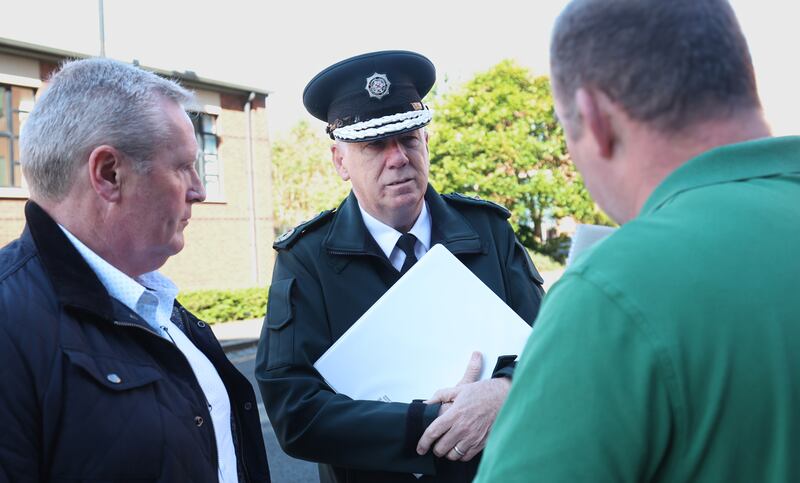 Chief Constable Jon Boutcher speaks to  Blue lights chair, Alan Gawne (left) and other protesters outside the policing board office on Thursday.
PICTURE COLM LENAGHAN