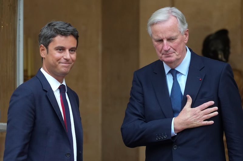 New prime minister of France, Michel Barnier, right, and outgoing French prime minister Gabriel Attal arrive for a handover ceremony in Paris on Thursday (Michel Euler/AP)