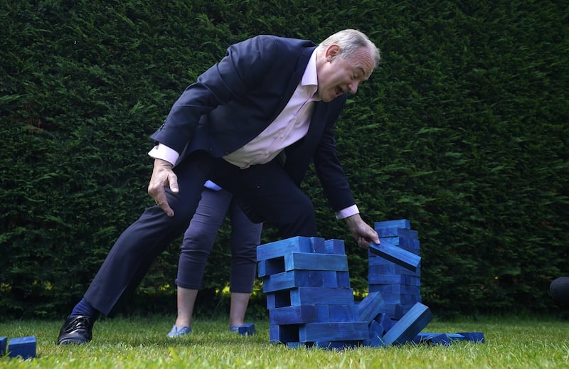 Liberal Democrats leader Sir Ed Davey plays Jenga with blue blocks representing the Conservative Party’s seats during a visit to Crowd Hill Farm, in Hampshire