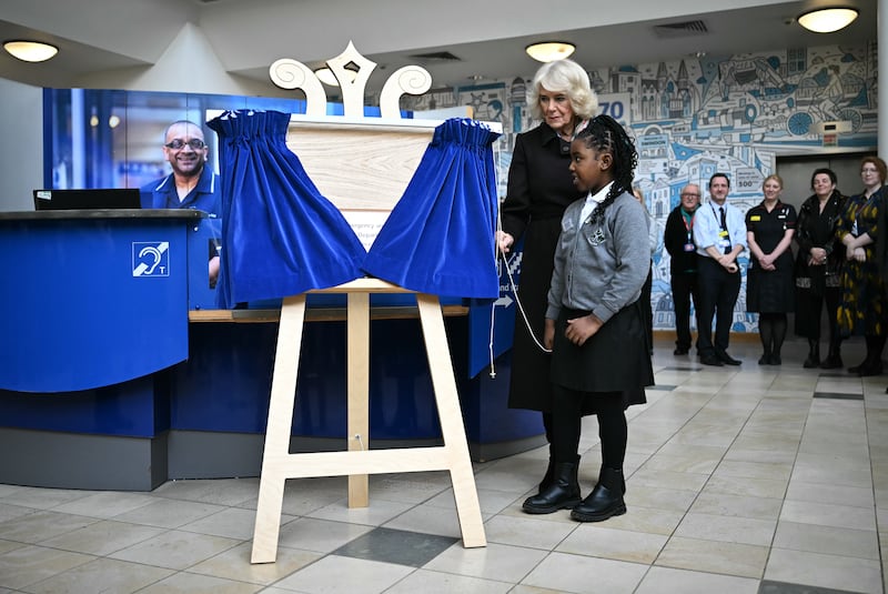 Camilla and nine-year-old Latoyah Vashi unveil a plaque to mark the royal visit