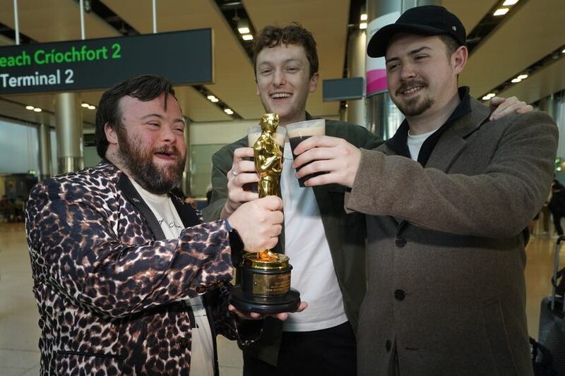 Actor James Martin, co-director Ross White and producer Pearce Cullen as the Oscar-wining team behind short film The Irish Goodbye arrives back at Dublin Airport (PA/Brian Lawless)