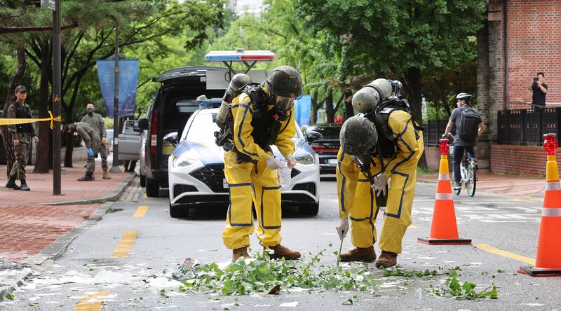 South Korean army soldiers wearing protective gear check debris from a balloon in Seoul (Park Dong-joo/Yonhap/AP)