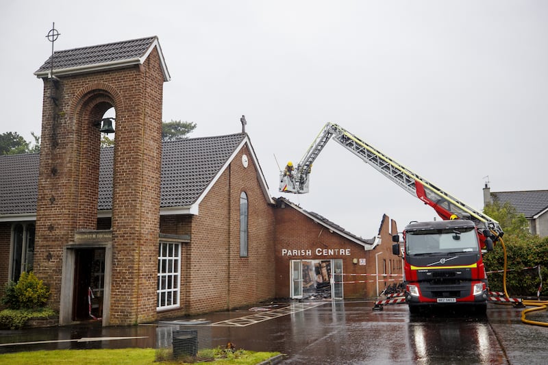 Firefighters at the Church of the Holy Name in Greenisland, Co Antrim, following a fire which started on Sunday night, causing significant damage to the Church of Ireland building and hall