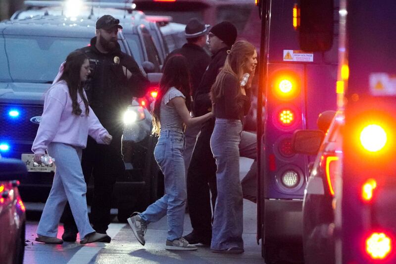 Students board a bus as they leave a shelter (Morry Gash/AP)