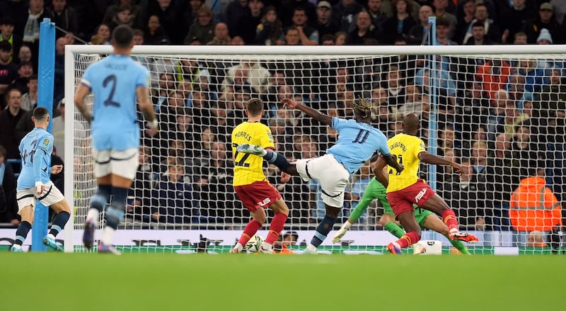 Jeremy Doku, centre right, scores Manchester City’s first goal against Watford