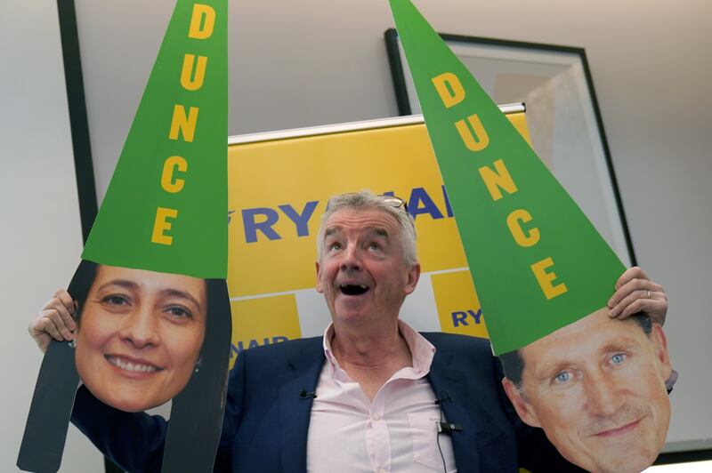 Ryanair chief executive Michael O’Leary holding up masks of Green Party politicians Eamon Ryan and Catherine Martin during a press conference last week