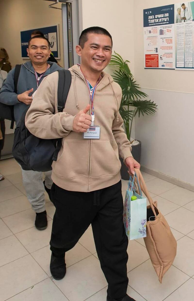 Pongsak Thaenna, front, and Surasak Rumnao, two of five Thai hostages who were freed from Hamas, arrive in Israel (Royal Thai Embassy in Tel Aviv/AP)