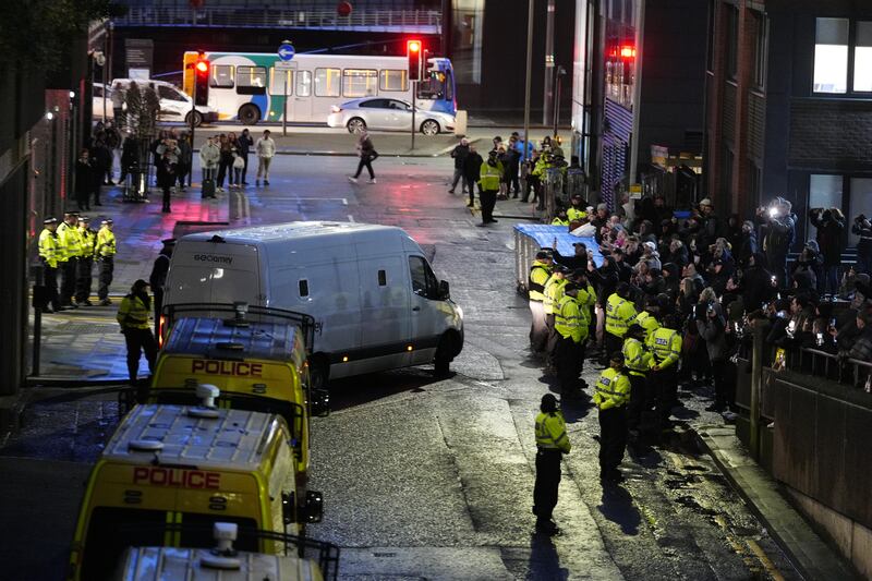 A prison van, watched by protesters, leaves Liverpool Crown Court, where Axel Rudakubana, 18, was detained for life with a minimum term of 52 years