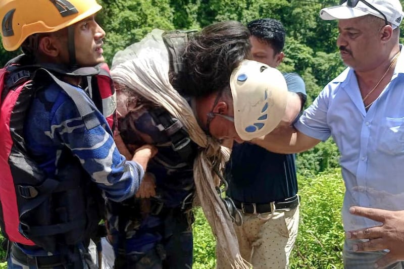 An injured passenger is taken from the scene (Nepal Armed Police Force via AP)