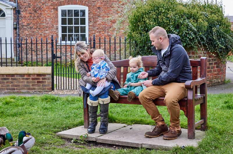 Margot loves spending time with her parents Laura (left), older sister Bernadette (middle) and dad John (right)