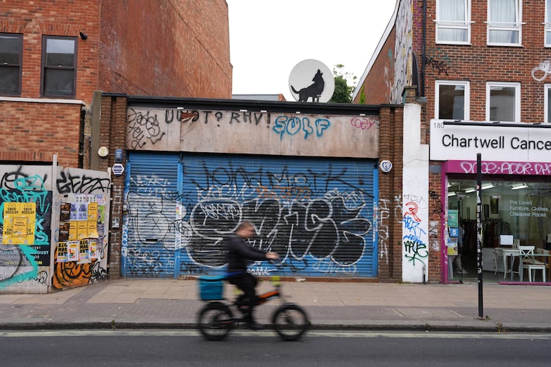 An artwork depicting a howling wolf was painted on a satellite dish placed on a shop roof in Peckham