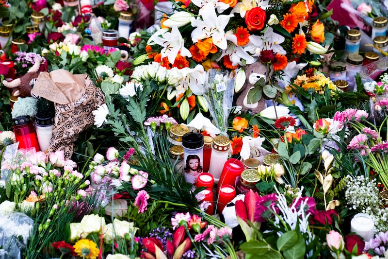 A sea of flowers and candles have been left at a makeshift memorial in front of Johannis church close to the Christmas market (Ebrahim Noroozi/AP)