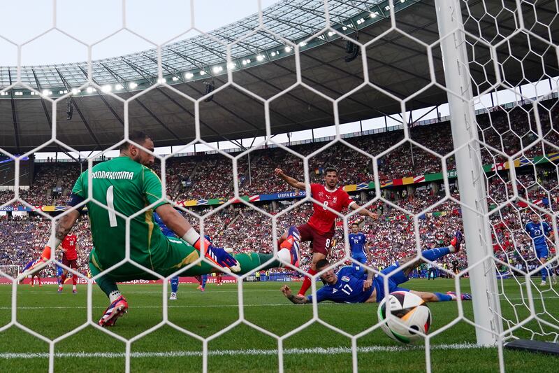 Switzerland’s Remo Freuler scores the opening goal past Italy goalkeeper Gianluigi Donnarumma in their round-of-16 tie