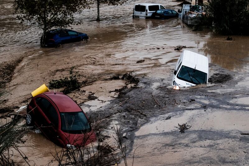 Cars being swept away in the town of Alora, Malaga (Gregorio Marrero/AP)