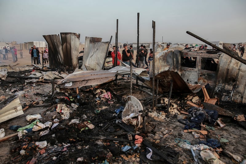 Palestinians look at the destruction after an Israeli strike where displaced people were staying in Rafah, Gaza Strip (Jehad Alshrafi/AP)