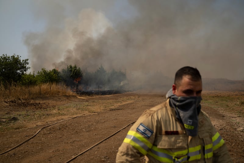 A firefighter near a fire burning in the Israeli-controlled Golan Heights (Leo Correa/AP)
