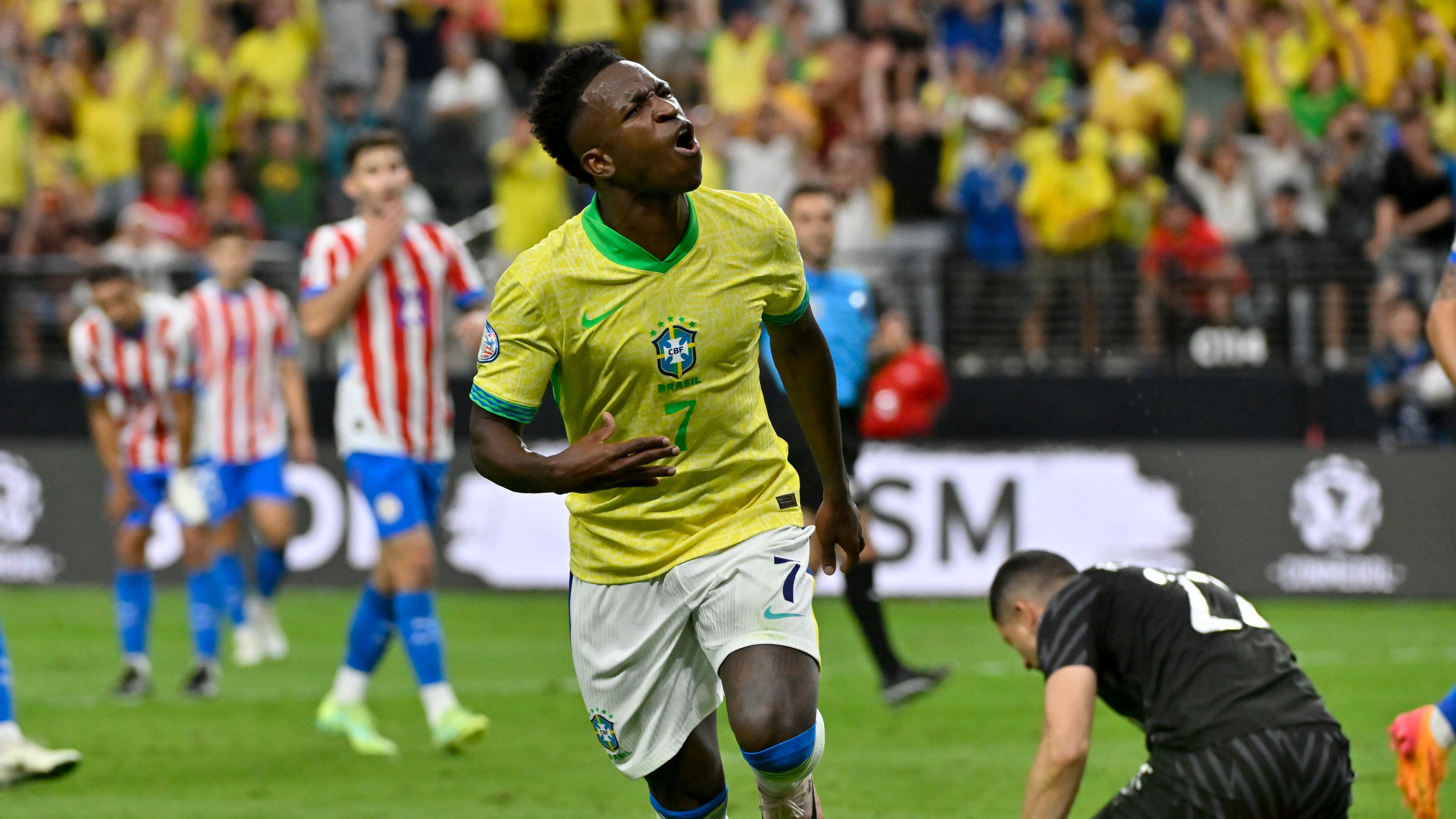 Brazil’s Vinicius Junior celebrates scoring his side’s opening goal against Paraguay (David Becker/AP)