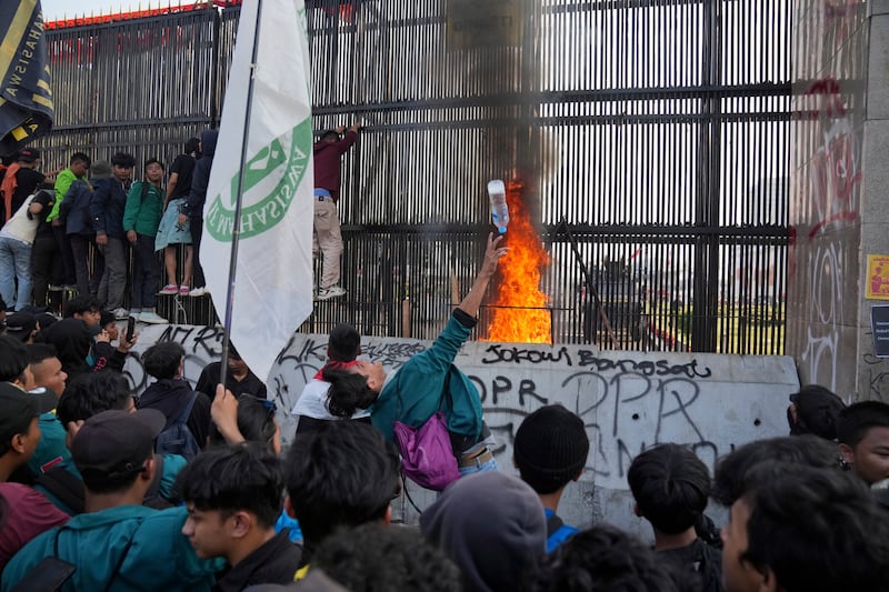 Protesters attempt to storm Indonesia’s parliament during a protest against controversial changes to election laws (Dita Alangkara/AP)