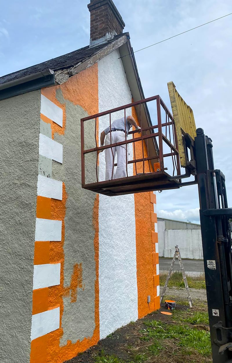 Painting a house Orange and White in Camlough ahead of Armagh’s All Ireland Final against Galway.
PICTURE COLM LENAGHAN