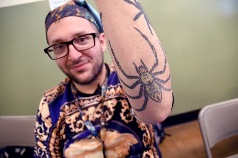 Student Goran Shikak shows off his spider tattoos (Thomas Peipert/AP)