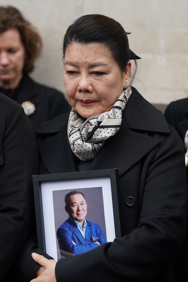 Aimon Srivaddhanaprabha holding a photo of her husband Khun Vichai