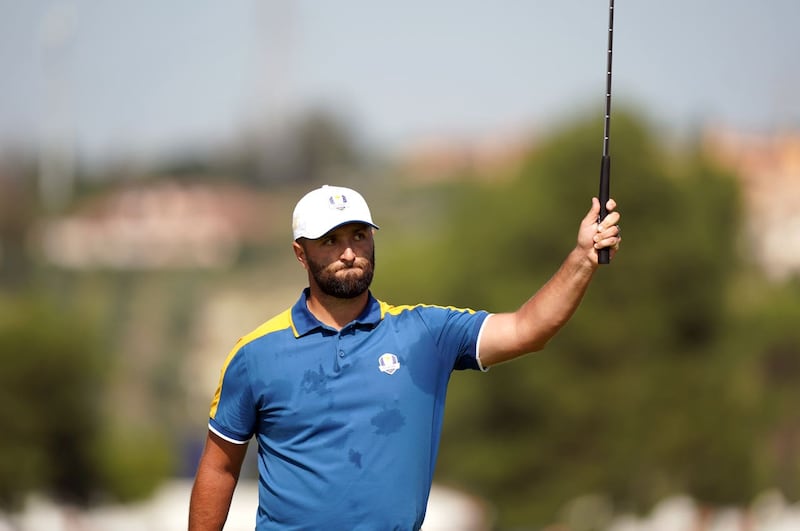 Jon Rahm celebrates winning the first hole against Scottie Scheffler