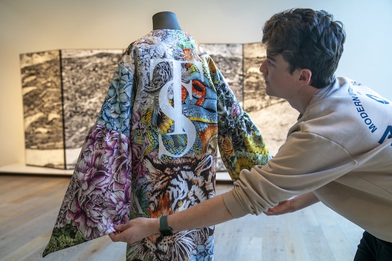 Museum content manager Chris Keatch examines the kimono inspired by Taylor Swift’s albums