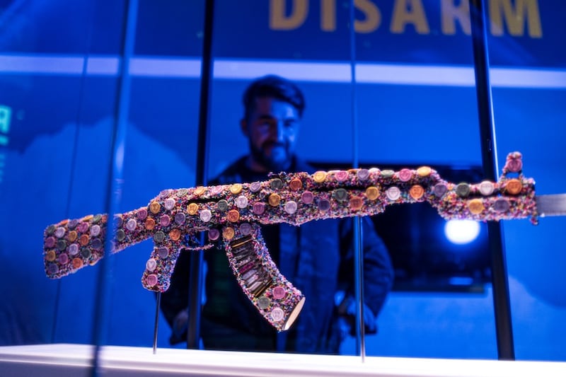 The exhibition also includes artworks by veteran-turned-artist Bran Symondson-Baxter, which includes two AK-47s decorated with sweets