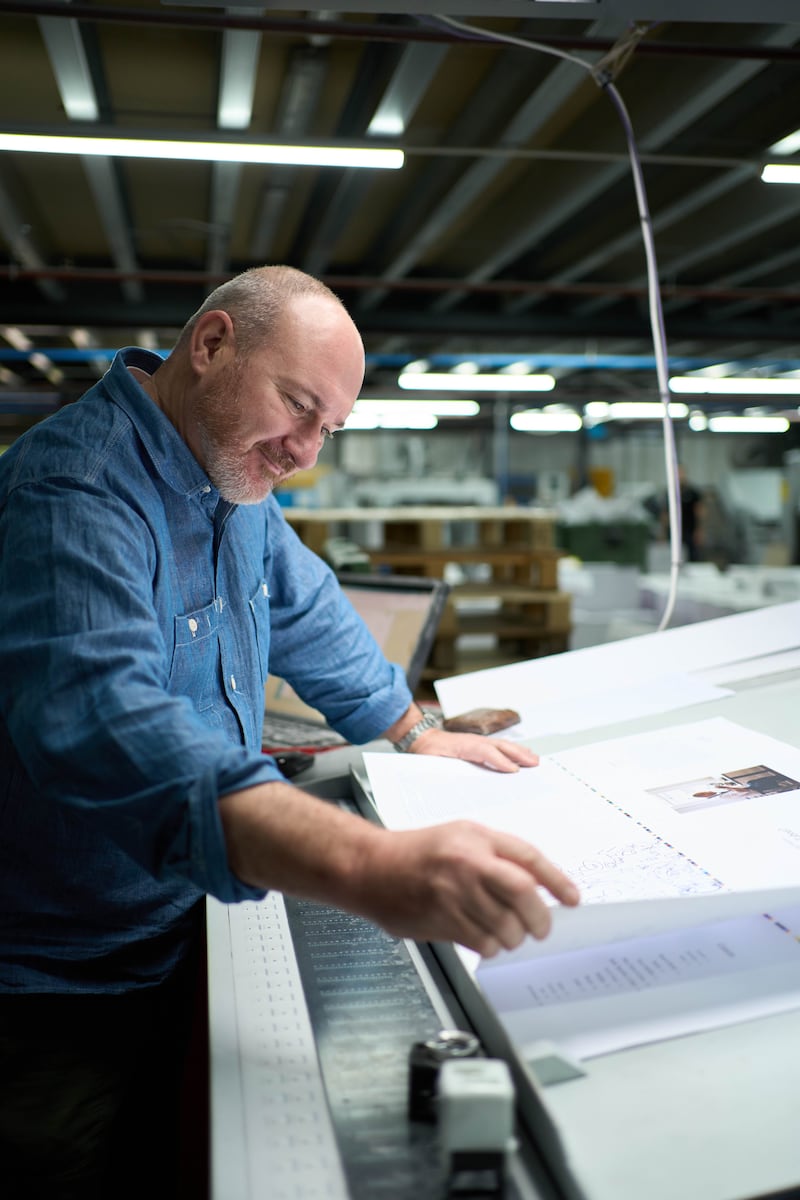 Chef Niall McKenna takes a closer look at a test print of his debut cookbook, What’s it all About? hot off the press at W&G Baird in Antrim