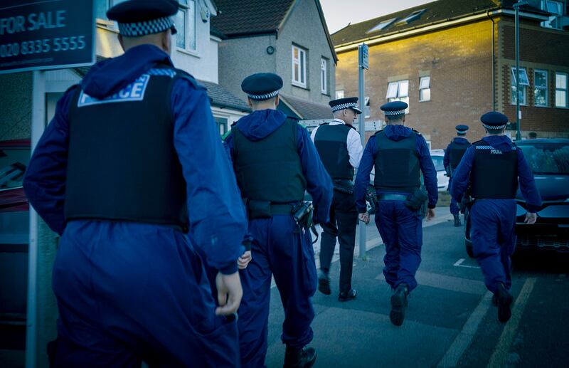 Met Police Commissioner Sir Mark Rowley (third from left) attended the arrests made in Sutton, south London