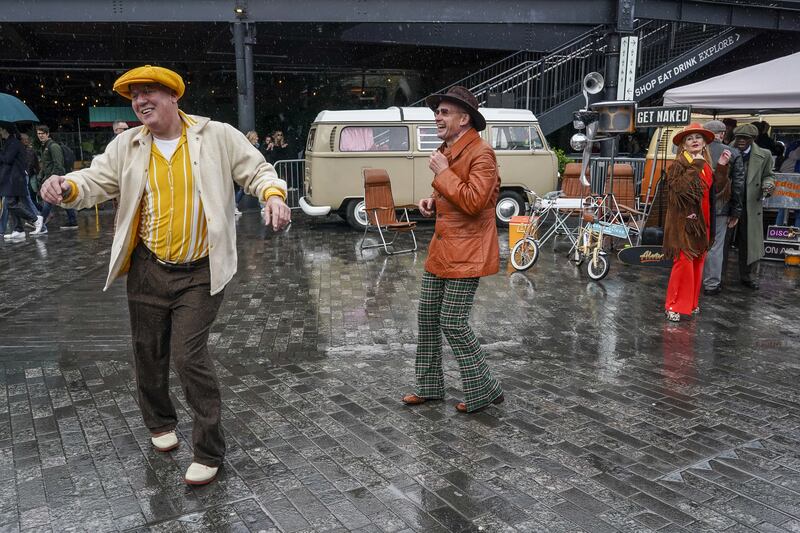 Rain failed to dampen spirits at a Classic Car Boot Sale at Kings Cross, London, on Sunday