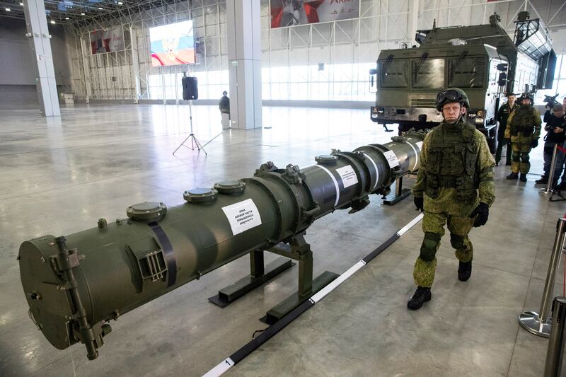 A Russian military officer walks past the 9M729 land-based cruise missile on display in Kubinka, outside Moscow, as Russian President Vladimir Putin calls for resuming production of intermediate-range missiles that were banned under a now-scrapped treaty with the US (Pavel Golovkin/AP)