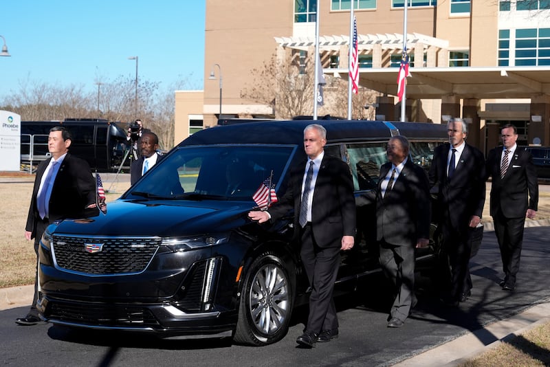 Former and current US Secret Service agents walk with the hearse (Alex Brandon/AP)