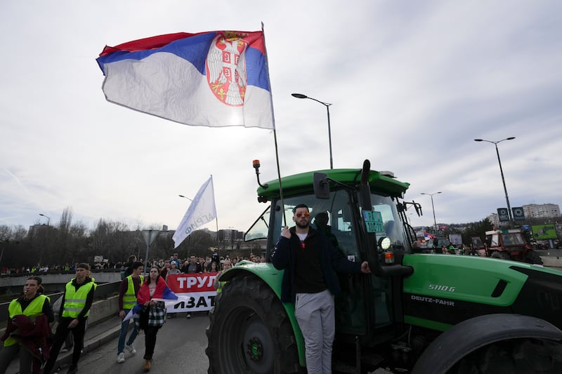 Farmers joined the student-led 24-hour blockade at an intersection in Belgrade on Monday (Darko Vojinovic/AP)