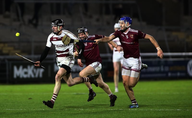 Slaughtneil star Brendan Rogers gallops away from Cushendall's Fergus McCambridge during Saturday night's epic Ulster Championship semi-final in Armagh. Picture by Seamus Loughran