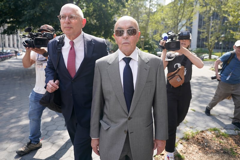 British billionaire Joe Lewis leaves, centre, Manhattan federal court at a previous hearing (Mary Altaffer/AP)