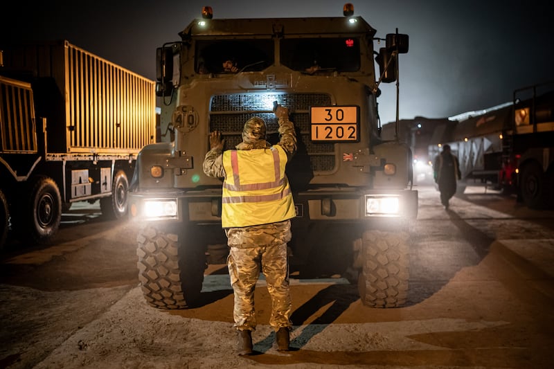 British military vehicles are inspected as they arrive at the military base at Szentes