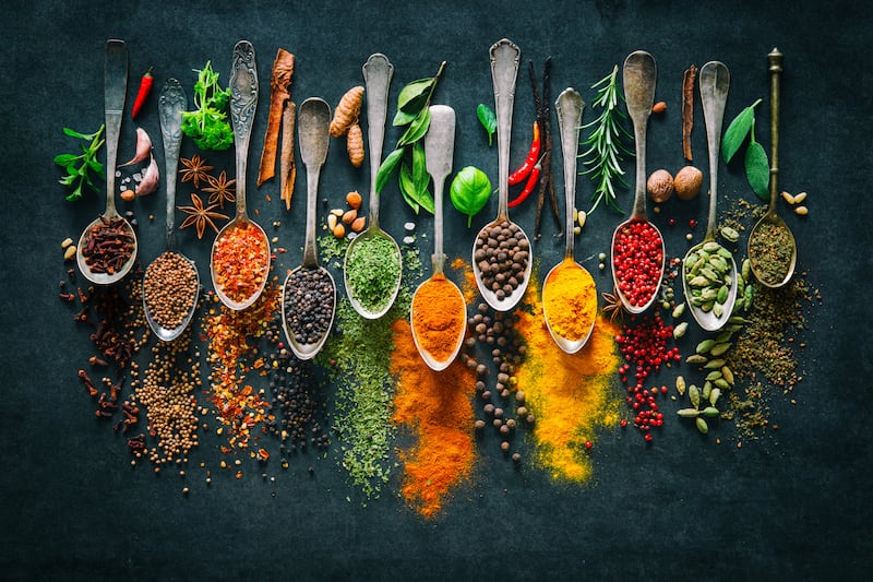 Colourful various herbs and spices for cooking on dark background