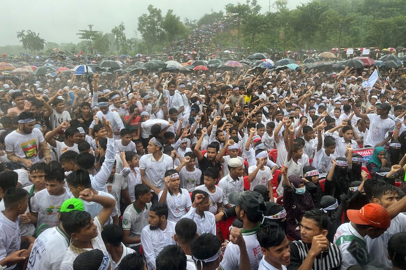 Hundreds of Rohingyas gather in the rain to demand a safe return to Myanmar’s Rakhine state as they mark the seventh anniversary of their mass exodus (Shafiqur Rahman/AP)