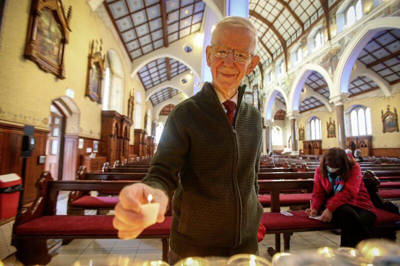 Lighting a candle at the Clonard Novena. Picture Mal McCann. 