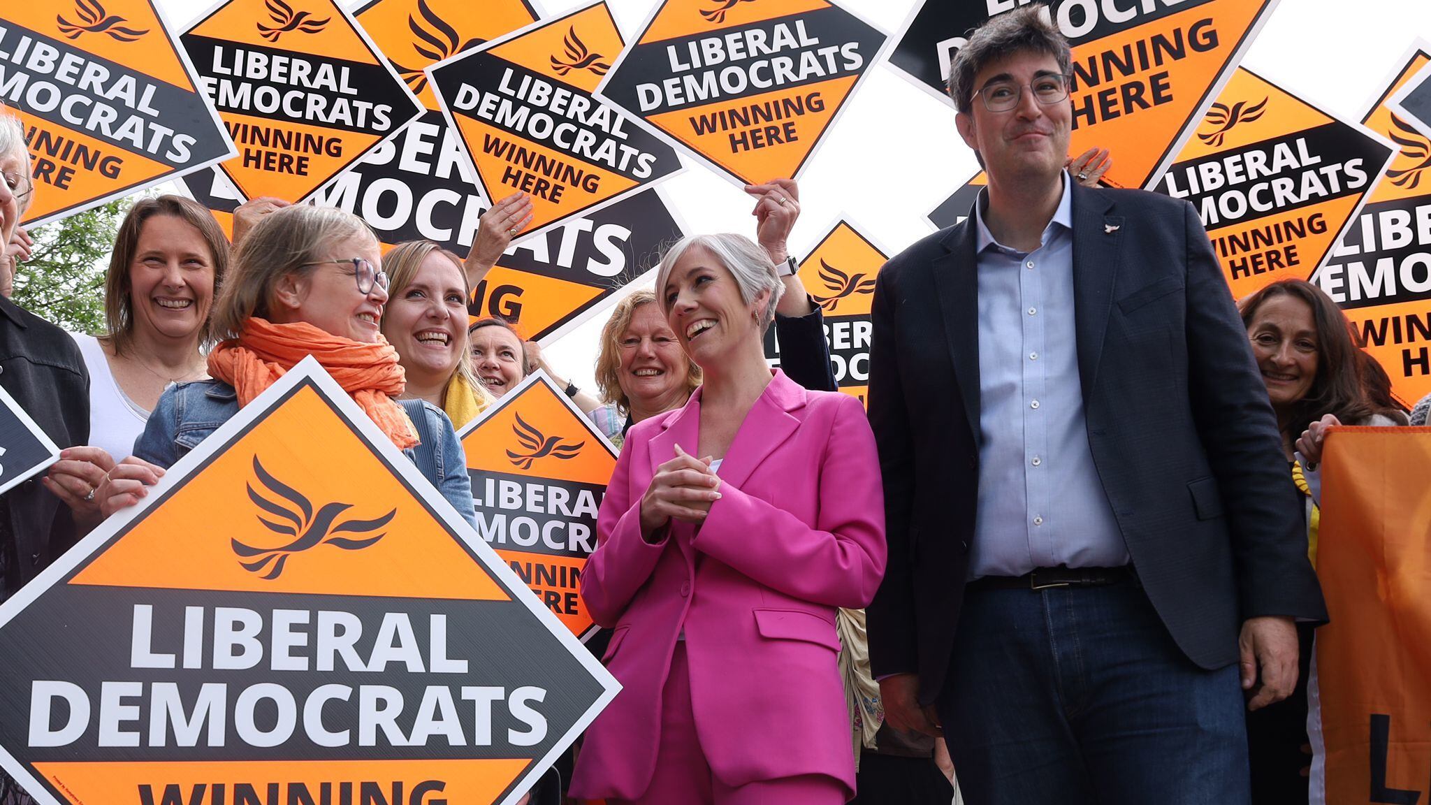 Liberal Democrat deputy leader Daisy Cooper (in pink) with Godalming and Ash candidate Paul Follows on the campaign trail in Surrey