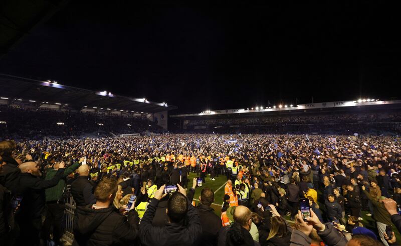 A Barnsley player was attacked after Portsmouth fans invaded the pitch in celebration of their side’s promotion to the Championship