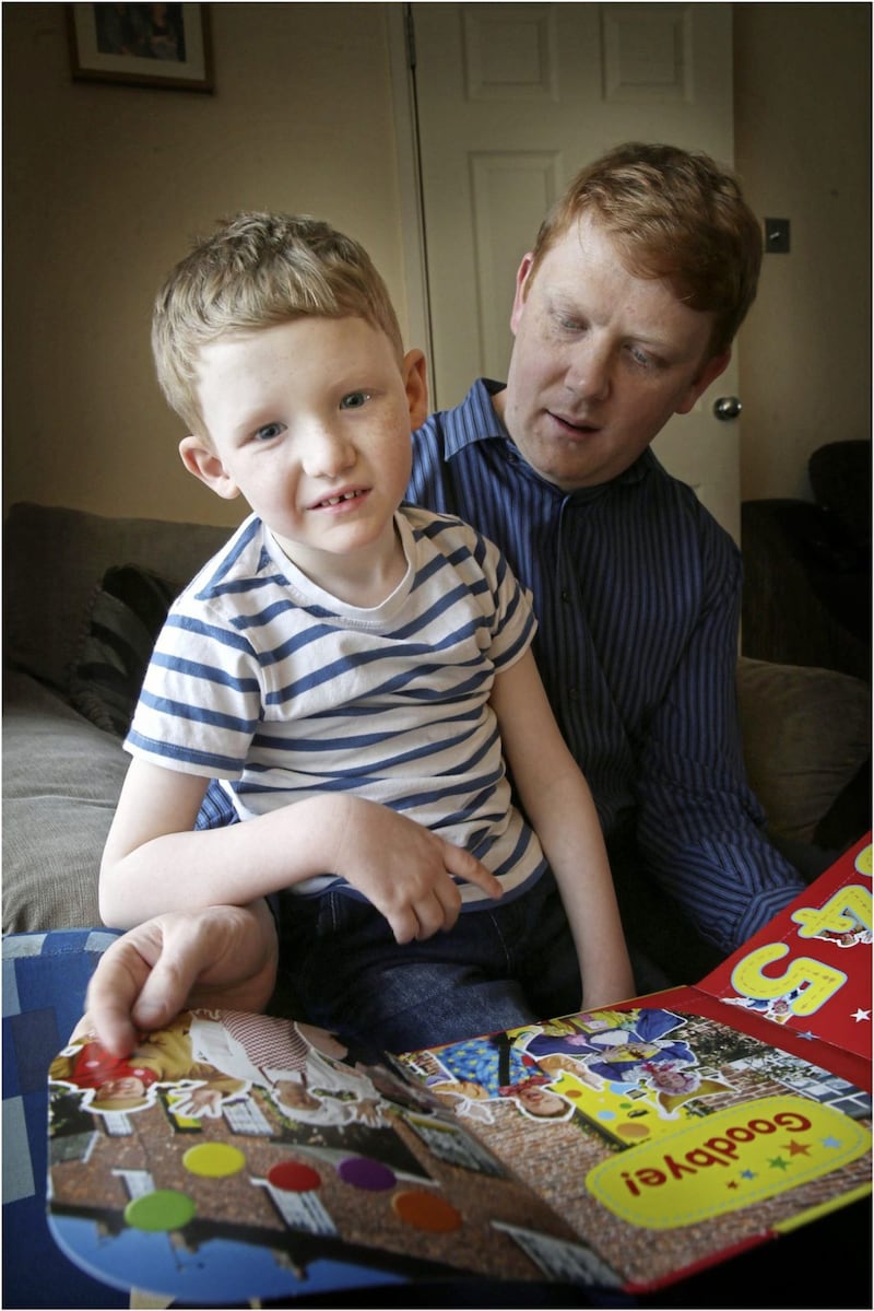 Six-year-old Archie Wooldridge with his dad Chris at their Newtownards, Co Down, home Picture: Hugh Russell 