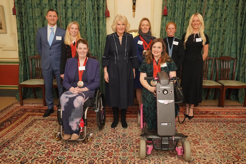 The Queen poses for a photo during a reception at Clarence House in London